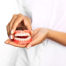 Holding dentures