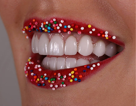 Woman smiling with sprinkles covering lips
