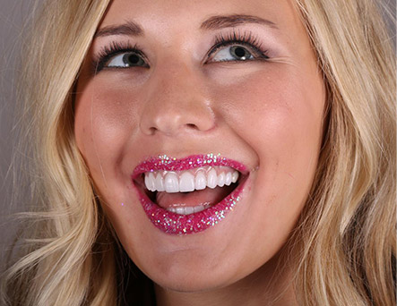 Young laughing woman with glittery lipstick