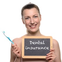 Woman holding dental insurance sign