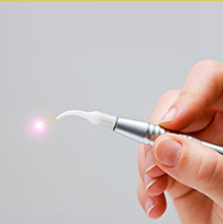 Dentist holding a soft tissue laser