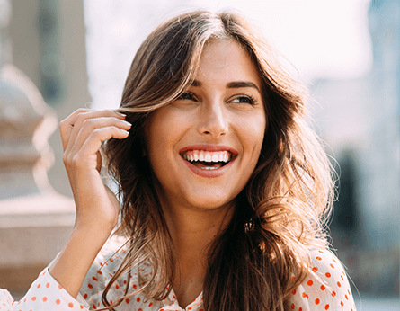 Young woman smiling in polka-dotted top