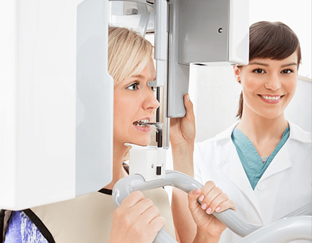 Female dental patient receiving x-ray