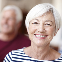 Elderly woman smiling in striped top