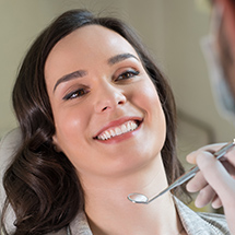 Dentist examining woman's mouth
