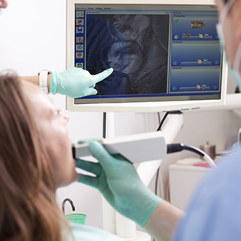 Joplin Restorative Dentistry dentist examining x-ray