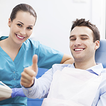 Male patient giving a thumbs up