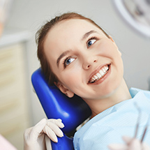 Young patient sitting in dental exam chair