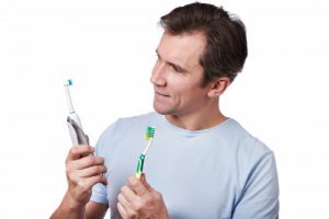man looking at toothbrushes