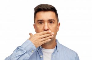 Man covering his mouth.