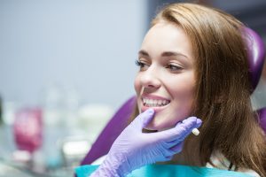 Smiling woman receiving dental treatment