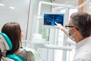 dentist showing patient X-ray