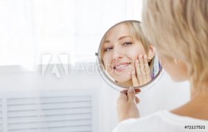 Woman smiling into mirror