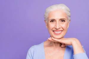 Smiling older woman with dental implants