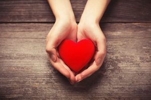 Small heart shape in cupped, outstretched hands.